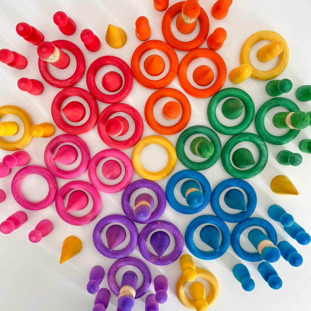 Here is a wide array of dyed wood toys that I made. There are wood rings, wooden peg people, wooden cones in rainbow colours.