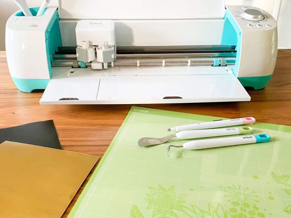 Cricut explore air, accessories and vinyl used to make a teacher toolbox